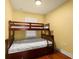 Cozy bedroom features a wooden bunk bed with white linens and hardwood floors, perfect for  at 2223 Amherst Ave, Orlando, FL 32804