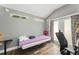 Bright and airy bedroom featuring neutral decor, large glass sliding door and wood-look flooring at 2223 Amherst Ave, Orlando, FL 32804