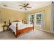 Bedroom featuring carpet, a ceiling fan, a bed and two windows overlooking the backyard at 2223 Amherst Ave, Orlando, FL 32804