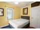 Bedroom with light yellow walls, a dark blue rug, and a queen-size bed at 2223 Amherst Ave, Orlando, FL 32804
