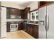 Well-equipped kitchen features stainless steel appliances, dark wood cabinetry, and granite countertops at 2223 Amherst Ave, Orlando, FL 32804