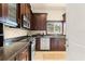 Updated kitchen features dark wood cabinets, stainless steel appliances, and a stylish tile floor at 2223 Amherst Ave, Orlando, FL 32804