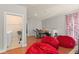 Living room with hardwood floors, red beanbag chairs, and access to laundry room at 2223 Amherst Ave, Orlando, FL 32804
