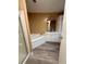 Well-lit bathroom featuring a jacuzzi tub, vanity, and modern fixtures at 2711 Cranmoor Dr, Kissimmee, FL 34758
