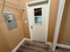 Hallway featuring gray wood-look floors, access door with window, and an electrical panel at 2711 Cranmoor Dr, Kissimmee, FL 34758