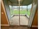 View out of a screened-in lanai to the green back yard at 2711 Cranmoor Dr, Kissimmee, FL 34758