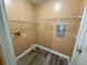 Functional laundry room with vinyl flooring and storage shelves at 2711 Cranmoor Dr, Kissimmee, FL 34758