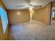 Bright living room features neutral walls, plush carpeting and abundant natural light at 2711 Cranmoor Dr, Kissimmee, FL 34758