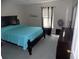 Simple bedroom featuring a dark bed frame and matching dresser at 2818 Sheila Dr, Apopka, FL 32712