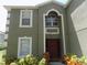 Inviting home exterior featuring a decorative front door and lush landscaping at 2818 Sheila Dr, Apopka, FL 32712