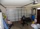 Interior view of a garage showing a metal garage door and various stored items at 2818 Sheila Dr, Apopka, FL 32712