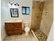 Bathroom with tile floors, updated vanity and tiled shower with window at 2829 Sanford Ave, Sanford, FL 32773