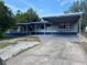 Charming single-story home featuring a covered carport and freshly painted in blue and grey at 2829 Sanford Ave, Sanford, FL 32773