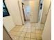 Hallway with tiled floors, access to several rooms and a closet with mirrored doors at 2829 Sanford Ave, Sanford, FL 32773