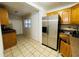 Open kitchen with stainless steel refrigerator, tile floors and ample cabinet space at 2829 Sanford Ave, Sanford, FL 32773