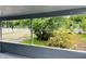 Covered porch area with serene views of the garden and street beyond at 2829 Sanford Ave, Sanford, FL 32773