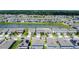 Beautiful aerial view of a community with well-maintained homes, some with solar panels, along a pond at 2943 Slough Creek Dr, Kissimmee, FL 34744