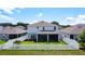 Expansive backyard featuring a screened patio and secured with a traditional white picket fence at 2943 Slough Creek Dr, Kissimmee, FL 34744