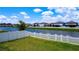 Inviting backyard with a secure white picket fence, offering tranquil pond views at 2943 Slough Creek Dr, Kissimmee, FL 34744