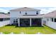 A spacious backyard featuring a screened-in patio and a classic white picket fence at 2943 Slough Creek Dr, Kissimmee, FL 34744