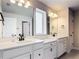 Modern bathroom features double sinks, quartz countertops, and sleek, dark hardware at 2943 Slough Creek Dr, Kissimmee, FL 34744