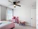 Charming bedroom showcasing a playful pink kitchen set, and a bright window offering comfort and natural light at 2943 Slough Creek Dr, Kissimmee, FL 34744
