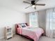 Cozy bedroom featuring a comfortable bed, stylish curtains, and a ceiling fan, offering a relaxing retreat at 2943 Slough Creek Dr, Kissimmee, FL 34744