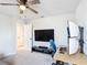 Functional bedroom features a mounted TV, and a ceiling fan that creates a comfortable and adaptable living space at 2943 Slough Creek Dr, Kissimmee, FL 34744