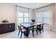 Elegant dining room with a dark wood table, modern chairs, and bright natural light at 2943 Slough Creek Dr, Kissimmee, FL 34744