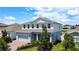 Beautiful two-story home with a brick driveway, lush landscaping, and a well-manicured lawn at 2943 Slough Creek Dr, Kissimmee, FL 34744