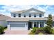 Charming two-story home featuring a two-car garage, well-manicured landscaping, and a welcoming front porch at 2943 Slough Creek Dr, Kissimmee, FL 34744