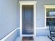 Charming home entrance with a stylish gray door and a welcoming 'Welcome Home' mat at 2943 Slough Creek Dr, Kissimmee, FL 34744