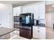 Modern kitchen showcasing stainless steel appliances, white cabinets, and granite countertops on the island at 2943 Slough Creek Dr, Kissimmee, FL 34744