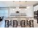 Spacious kitchen island featuring granite countertops, stainless steel sink, and seating for four people at 2943 Slough Creek Dr, Kissimmee, FL 34744