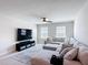 Cozy living room with large sectional sofa, TV, and ceiling fan; perfect for Gathering gatherings at 2943 Slough Creek Dr, Kissimmee, FL 34744