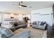 Bright and spacious living room featuring comfortable seating, a ceiling fan, and an open layout at 2943 Slough Creek Dr, Kissimmee, FL 34744