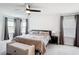 Bright main bedroom features large windows, a plush bed, and a stylish bench at 2943 Slough Creek Dr, Kissimmee, FL 34744