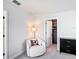 Bright sitting area features a comfortable chair and lamp and offers access to closet space at 2943 Slough Creek Dr, Kissimmee, FL 34744