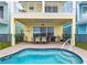 This backyard shows a splash pool and a patio area for entertaining with an outdoor grill at 3036 Parrot Head Pl, Kissimmee, FL 34747