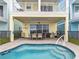 This backyard shows a splash pool and a patio area for entertaining with an outdoor grill at 3036 Parrot Head Pl, Kissimmee, FL 34747