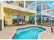 This backyard shows a splash pool and a patio area for entertaining with an outdoor grill at 3036 Parrot Head Pl, Kissimmee, FL 34747