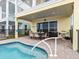 This backyard shows a splash pool and a patio area for entertaining with an outdoor grill at 3036 Parrot Head Pl, Kissimmee, FL 34747