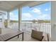 Enjoy the water view from this balcony with comfortable seating and white railings at 3036 Parrot Head Pl, Kissimmee, FL 34747