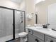 Neutral bathroom features a gray vanity and walk-in shower with black hardware at 3036 Parrot Head Pl, Kissimmee, FL 34747