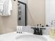 Elegant bathroom vanity with marble countertop, black faucet, and shower with glass door at 3036 Parrot Head Pl, Kissimmee, FL 34747