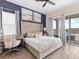 Beautiful bedroom with a decorative headboard, lake view, and complementary accent wall at 3036 Parrot Head Pl, Kissimmee, FL 34747