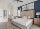 Spacious primary bedroom featuring luxury vinyl floors, ensuite bath, and lake views at 3036 Parrot Head Pl, Kissimmee, FL 34747