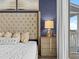Close-up of a primary bedroom with a decorative headboard and ambient lighting at 3036 Parrot Head Pl, Kissimmee, FL 34747
