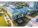 Aerial view of a commercial building, palm trees, a shuffleboard court, and a parking lot at 3036 Parrot Head Pl, Kissimmee, FL 34747