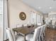 Bright dining room with a long table, stylish chairs, and a decorative mirror is perfect for gatherings at 3036 Parrot Head Pl, Kissimmee, FL 34747